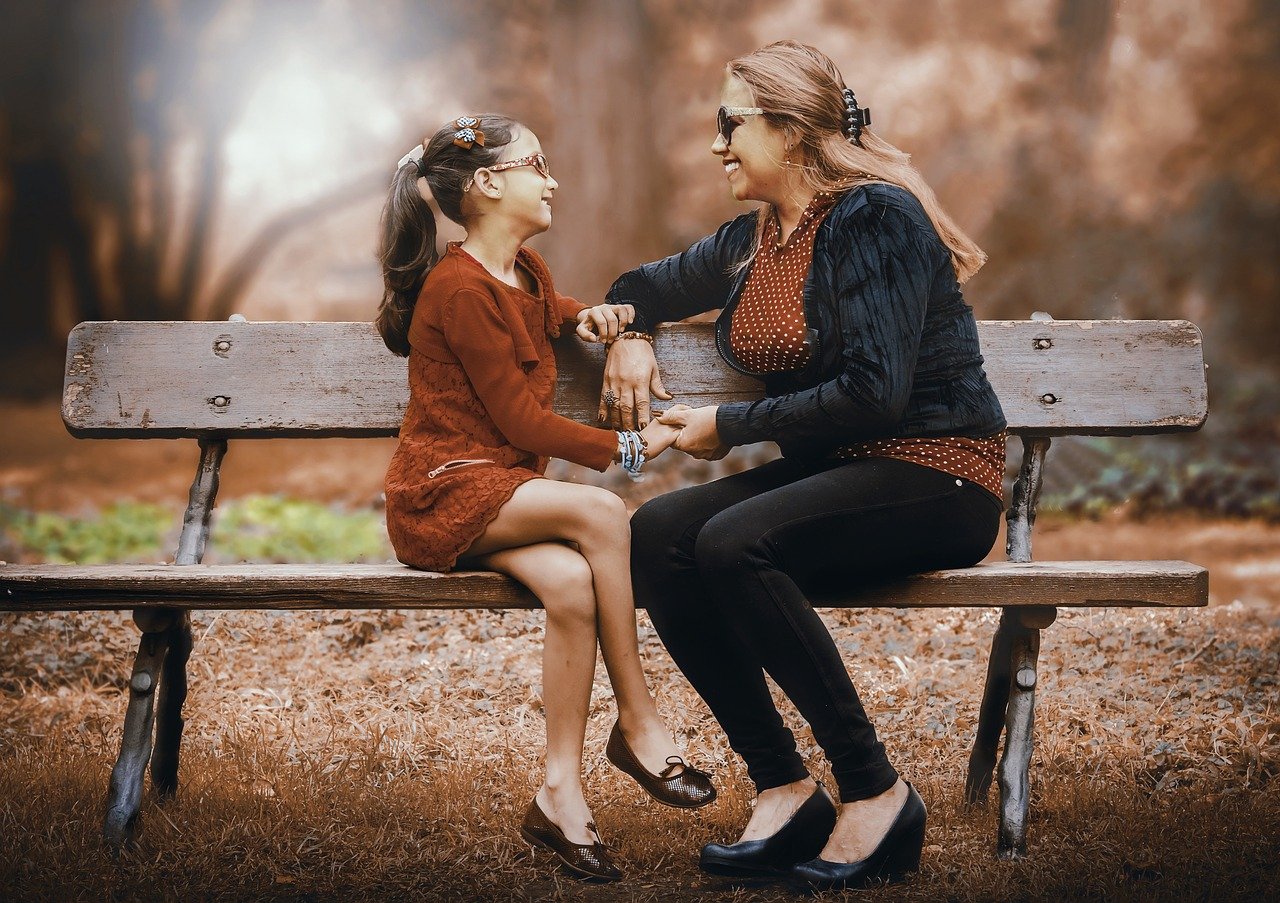 Mother and Daughter enjoying a fun moment at the park (Right to Left).